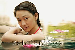Asia Images Group - Young woman in swimming pool, looking at camera