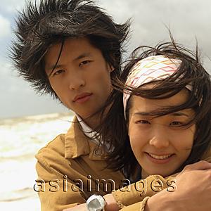 Asia Images Group - Couple embracing, looking at camera