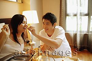 Asia Images Group - Couple having breakfast in bed