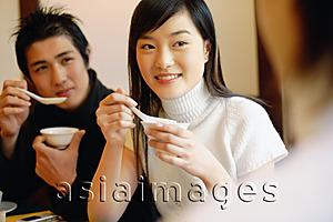 Asia Images Group - Friends at restaurant, eating soup