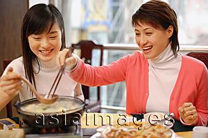 Asia Images Group - Young women eating at a restaurant