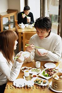 Asia Images Group - Young adults eating at a restaurant
