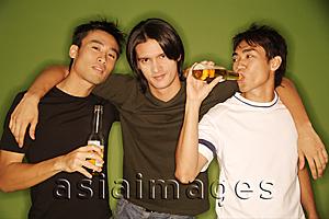 Asia Images Group -  Three young men, arm around each other, facing camera