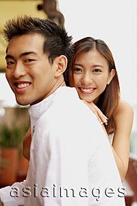 Asia Images Group - Young man in profile, young woman in front of him, smiling