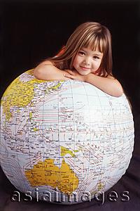 Asia Images Group - Girl leaning on globe
