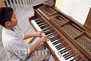 Asia Images Group - Boy playing the piano