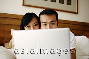 Asia Images Group - Couple in bed using laptop