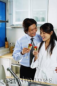 Asia Images Group - Couple in kitchen holding champagne