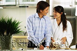 Asia Images Group - Couple in kitchen washing dishes