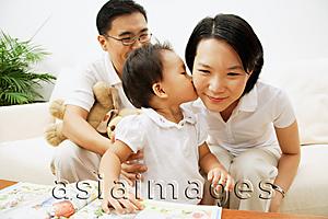 Asia Images Group - Family with one child, daughter kissing mother