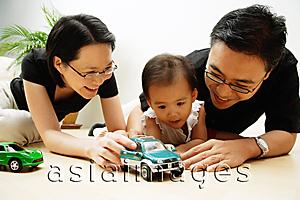 Asia Images Group - Family with one child, playing with cars