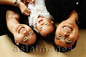 Asia Images Group - Family with one child lying on floor looking at camera