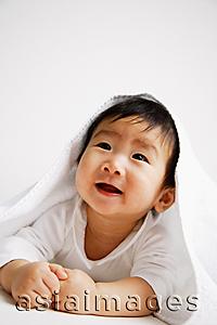 Asia Images Group - Baby boy peeking out from under blanket, portrait