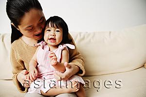 Asia Images Group - Mother with young daughter on sofa, bonding