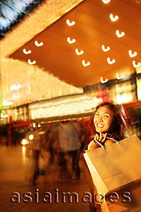 Asia Images Group - Young woman, carrying shopping bag over shoulder