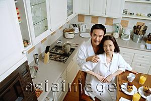 Asia Images Group - Couple in kitchen, smiling at camera, high angle view