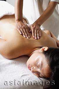 Asia Images Group - Woman lying on massage table, having back massaged