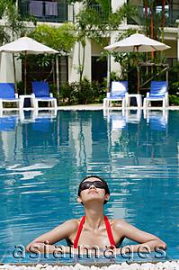 Asia Images Group - Woman in swimming pool, wearing sunglasses