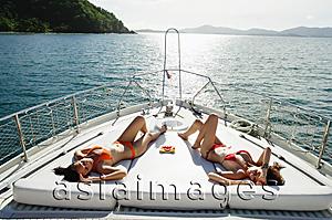 Asia Images Group - Women sunbathing on boat deck