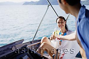 Asia Images Group - Couple on yacht, toasting with drinks