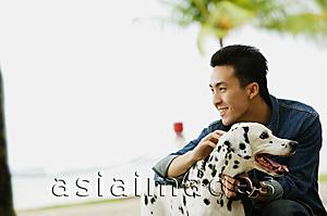 Asia Images Group - Man petting his Dalmatian dog