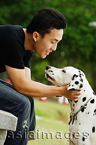 Asia Images Group - Man with his Dalmatian dog, side view