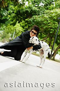 Asia Images Group - Woman embracing Dalmatian