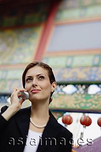 Asia Images Group - Businesswoman using mobile phone, portrait