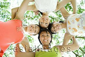 Asia Images Group - Young women standing side by side, looking down at camera
