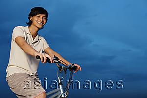 Asia Images Group - Man on bicycle, smiling at camera