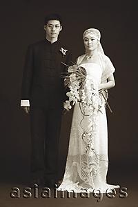 Asia Images Group - Bride and Groom posing for studio portrait