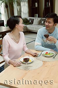Asia Images Group - Couple sitting at home having a meal