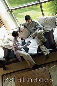 Asia Images Group - Couple at home doing finances, high angle view