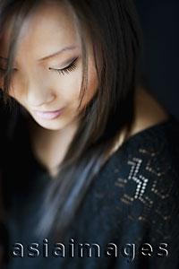 Asia Images Group - Head shot of woman looking down