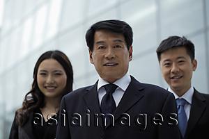Asia Images Group - Business people standing together outdoors, smiling