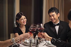 Asia Images Group - People toasting during a dinner party