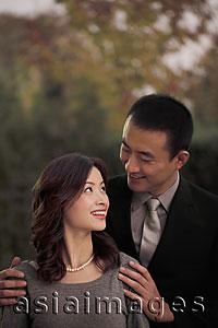 Asia Images Group - Young couple looking at each other and smiling
