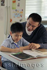 Asia Images Group - Father helping son with his homework