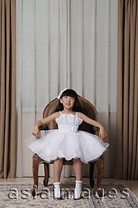Asia Images Group - Young girl dressed up in white dress looking up