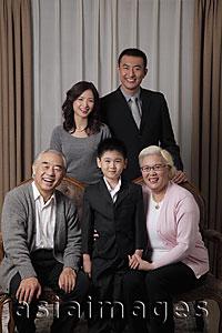 Asia Images Group - Three generational family posing for a photo together