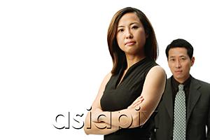 AsiaPix - Woman with arms crossed, looking at camera, man behind her