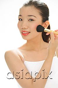 AsiaPix - Woman applying blusher with make-up brush