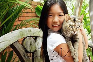 AsiaPix - Girl holding cat, looking at camera, smiling