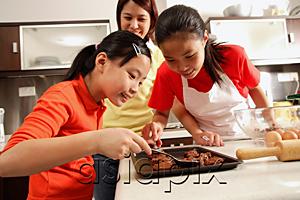 AsiaPix - Mother and two daughters in kitchen, baking