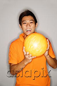 AsiaPix - Man holding bowling ball, smiling at camera