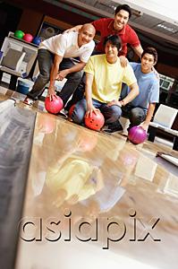 AsiaPix - Four men in bowling alley, looking at camera