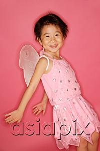 AsiaPix - Young girl in pink dress with artificial wings, smiling at camera, hands stretched behind her
