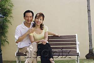 AsiaPix - Mature couple sitting on bench, smiling at camera
