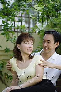 AsiaPix - Mature couple sitting together, looking at each other, smiling
