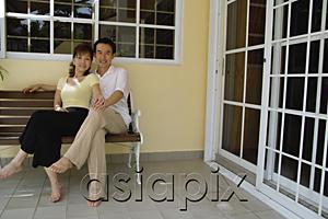 AsiaPix - Couple sitting on bench in patio, holding hands